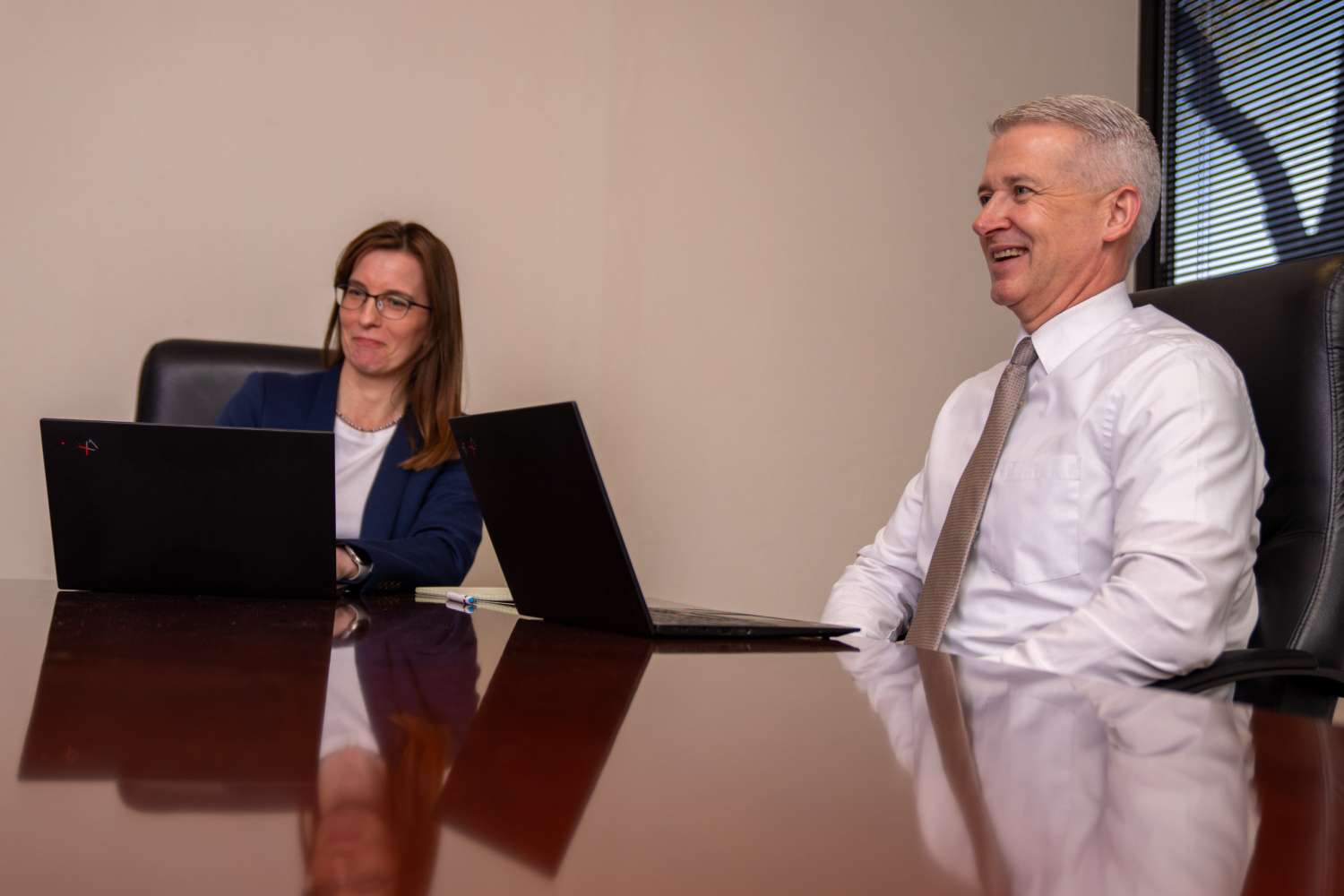 ESLaw_Website-09 two attorneys chuckle at a table