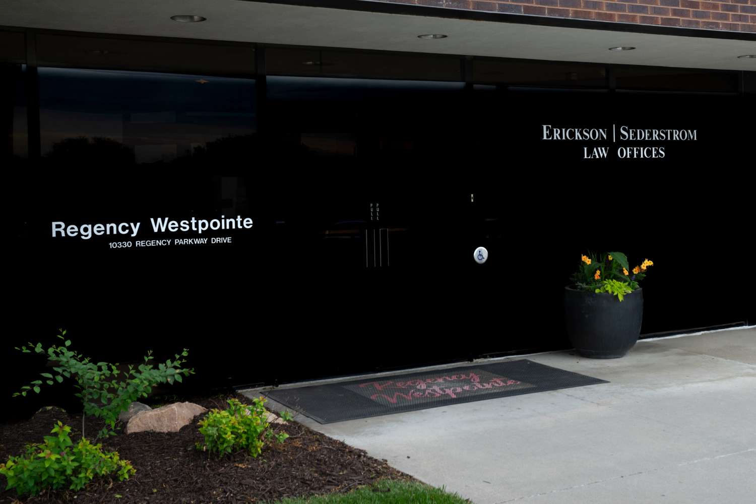LGX-ESLAW_2025-05-23_023 Door to ES Law offices with text: Erickson | Sederstom law offices, regency westpointe 10330 regency parkway Drive