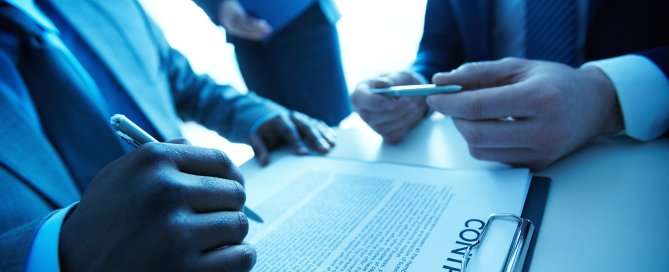 Image of contract on workplace and group of partners making decision to sign it